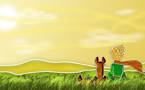 le petit prince et le renard de dos assis dans l’herbe