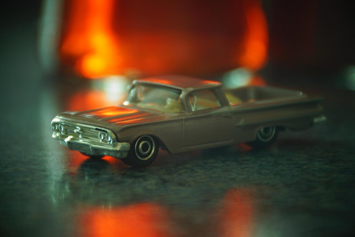 Voiture miniature stylisée posée sur une surface marbrée.