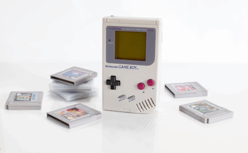 Une console Gameboy entourée de ses cartouches de jeu.