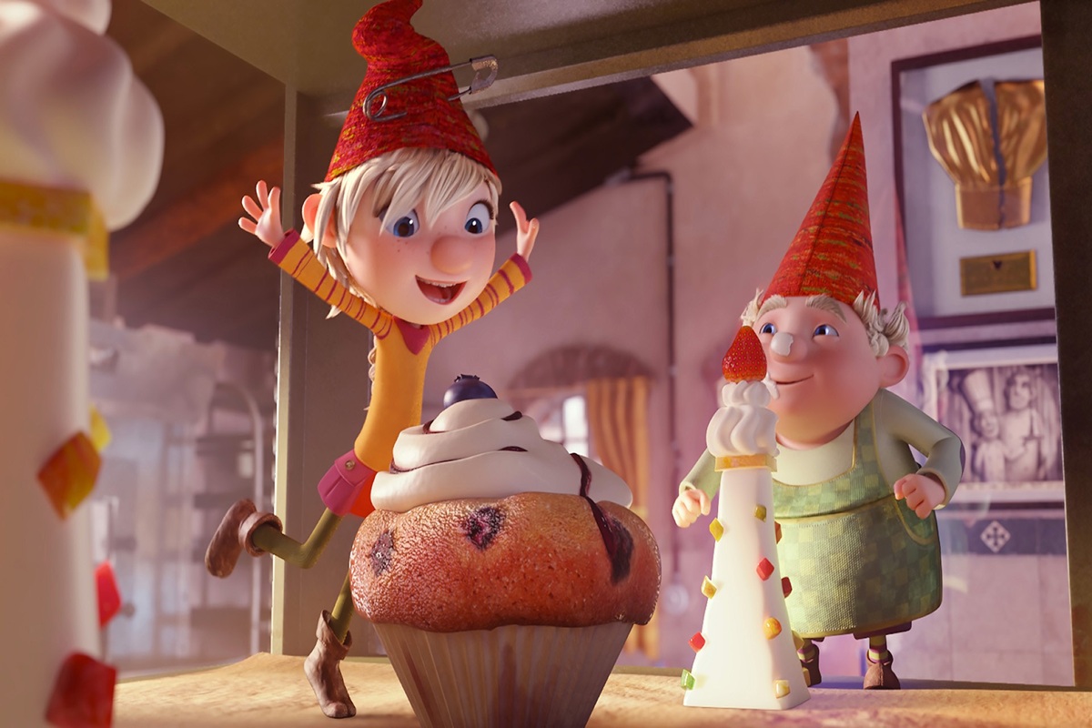 Elfie l'elfe joyeuse avec une pâtisserie géante